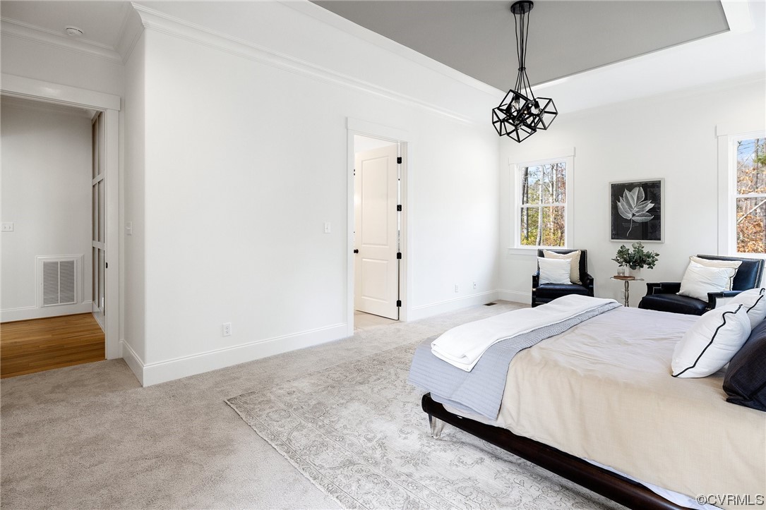 5143 Lake Summer Loop Moseley, VA 23120 - Photo 32 of 49 a spacious bedroom with a bed and a chandelier