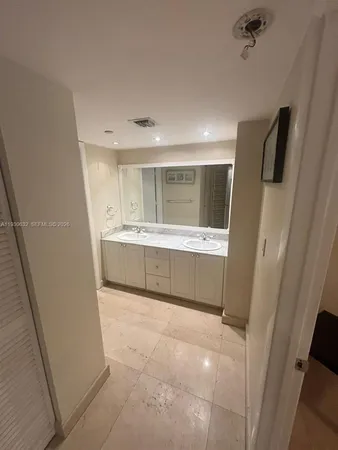 a large bathroom with a double vanity sink and mirror