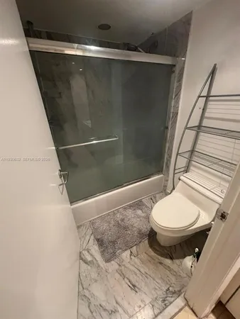 a bathroom with a toilet and a shower