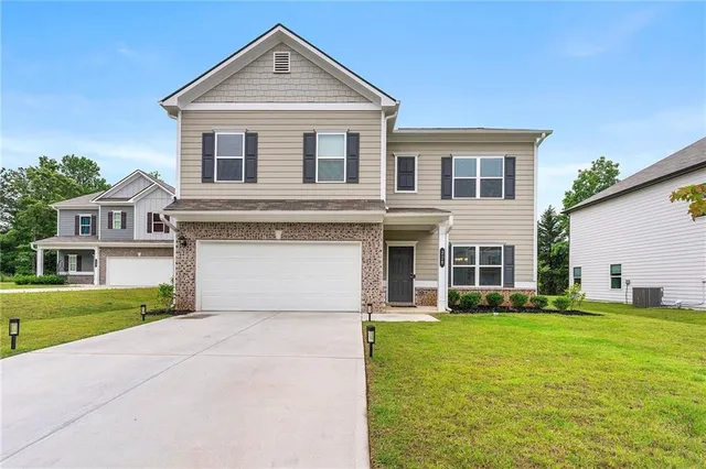 a front view of house with yard and green space