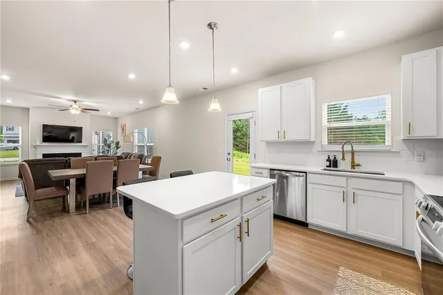a large kitchen with kitchen island a sink table and chairs