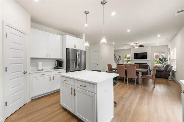 a large kitchen with kitchen island a sink table and chairs