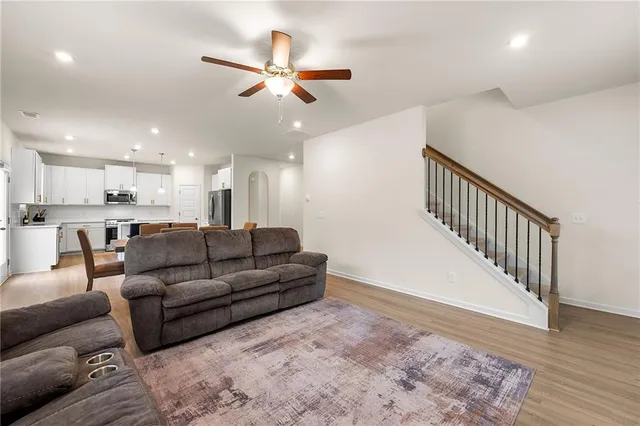 a living room with furniture and kitchen view