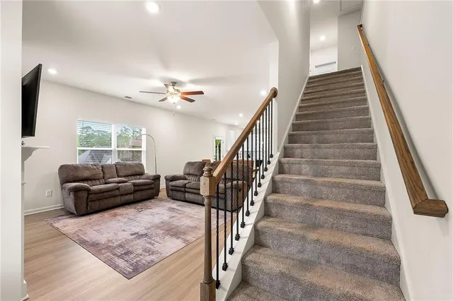 a living room with furniture and stairs