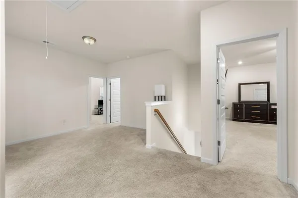 an empty room with a mirror and stairs