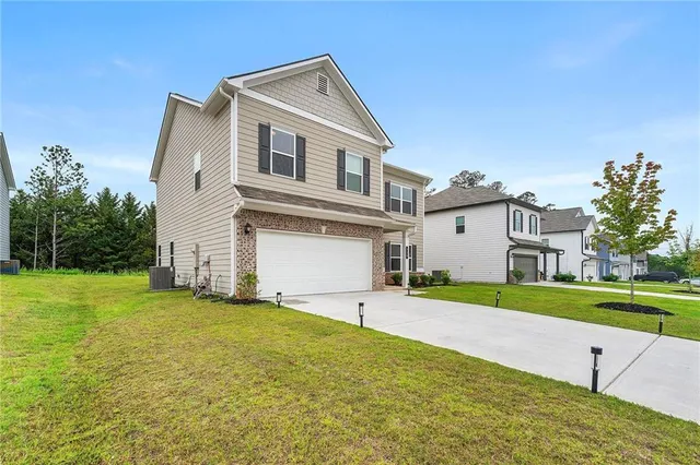 a front view of a house with a yard and garage