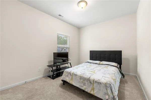 a bed sitting in a room next to a window
