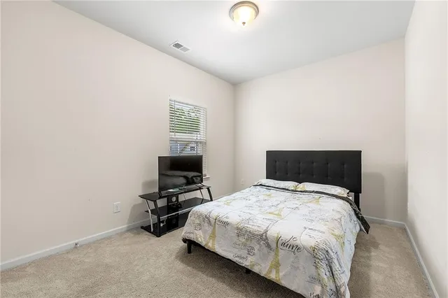 a bed sitting in a room next to a window