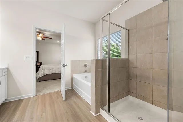 a en suite bathroom with a sink a mirror and a bathtub