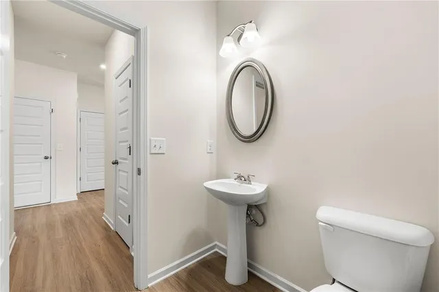 a bathroom with a toilet sink and a mirror