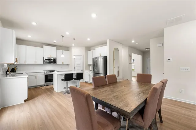 a large kitchen with a table and chairs