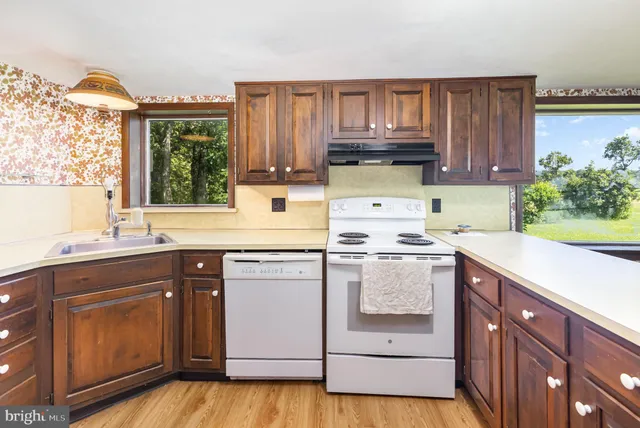a kitchen with a sink stove and cabinets