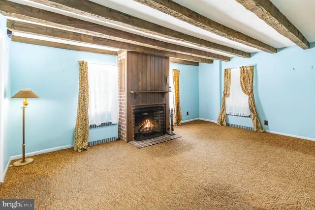 a view of an empty room with a fireplace