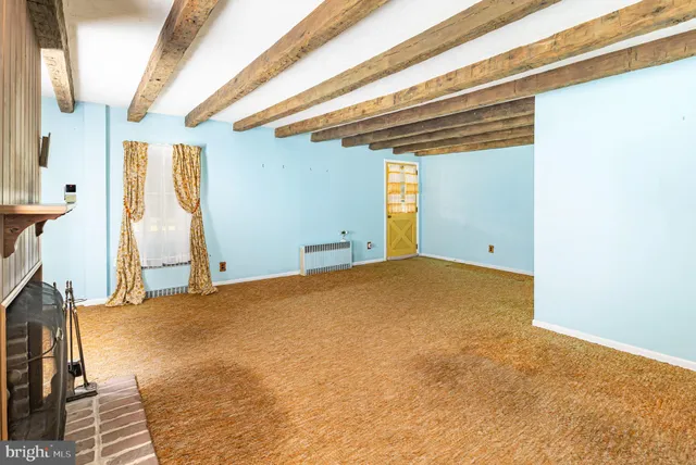 a view of room with window and refrigerator