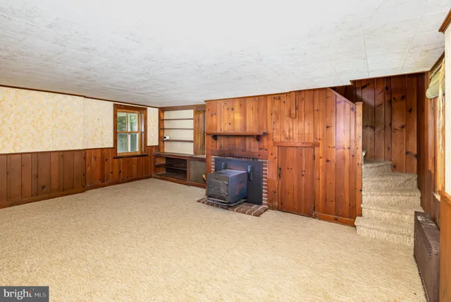an empty room with furniture and windows