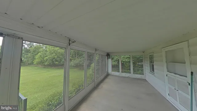 a view of a room with sliding glass door and shower