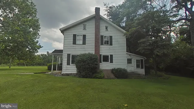 a front view of house with a garden