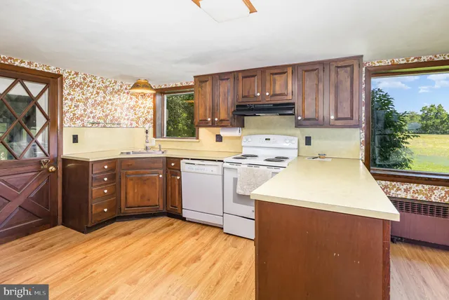 a kitchen with a sink a stove and cabinets
