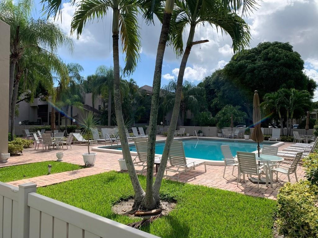 159 Northwest 70th Street, Unit 517 Boca Raton, FL 33487 - Photo 1 of 30 a view of a swimming pool with a patio