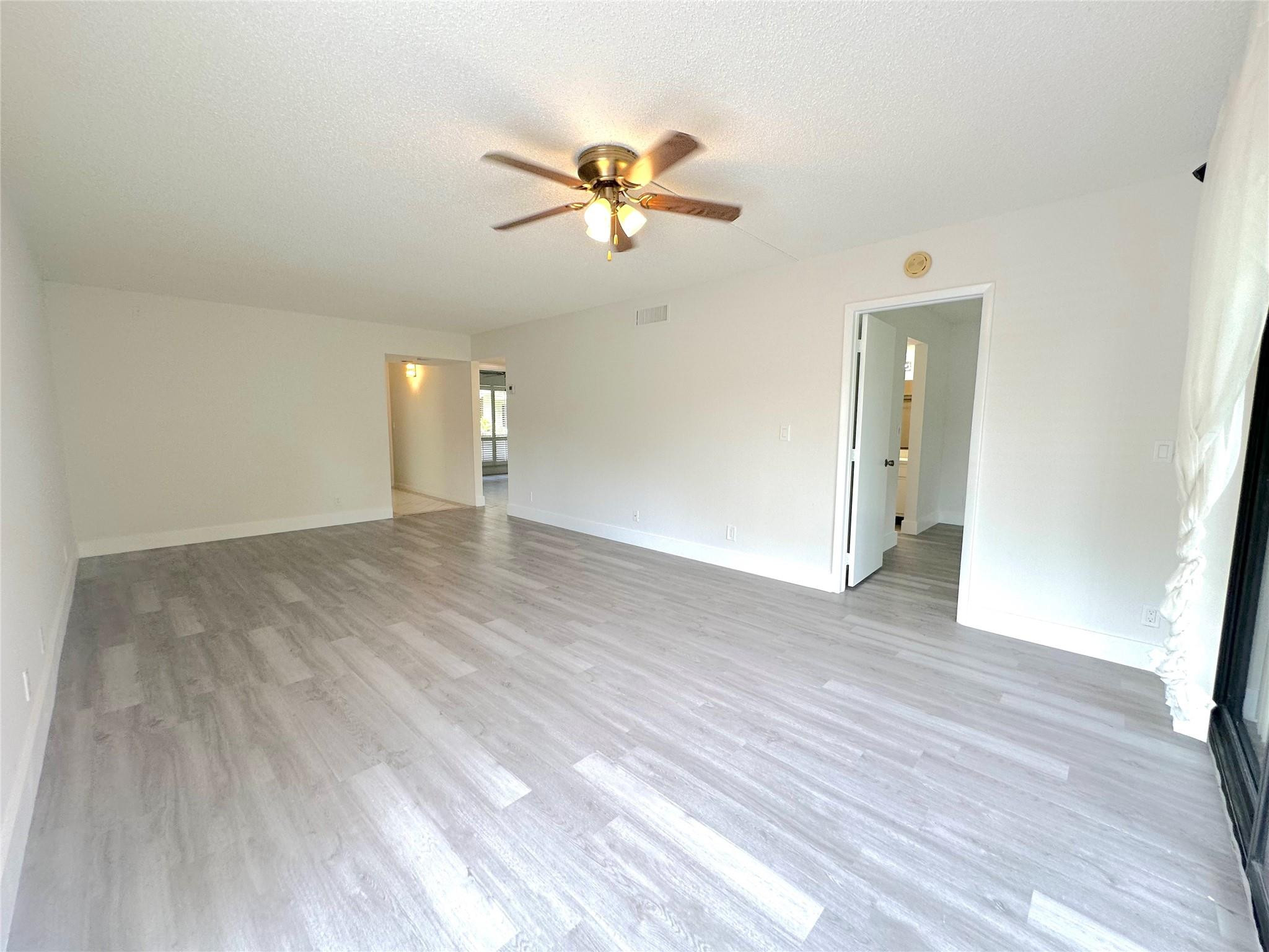 159 Northwest 70th Street, Unit 517 Boca Raton, FL 33487 - Photo 11 of 30 a view of empty room with wooden floor