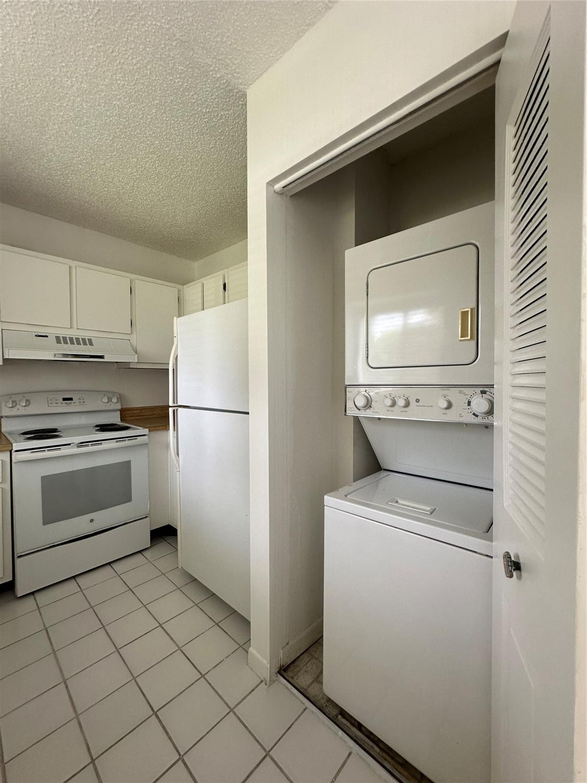 159 Northwest 70th Street, Unit 517 Boca Raton, FL 33487 - Photo 13 of 30 a kitchen with white cabinets and white appliances
