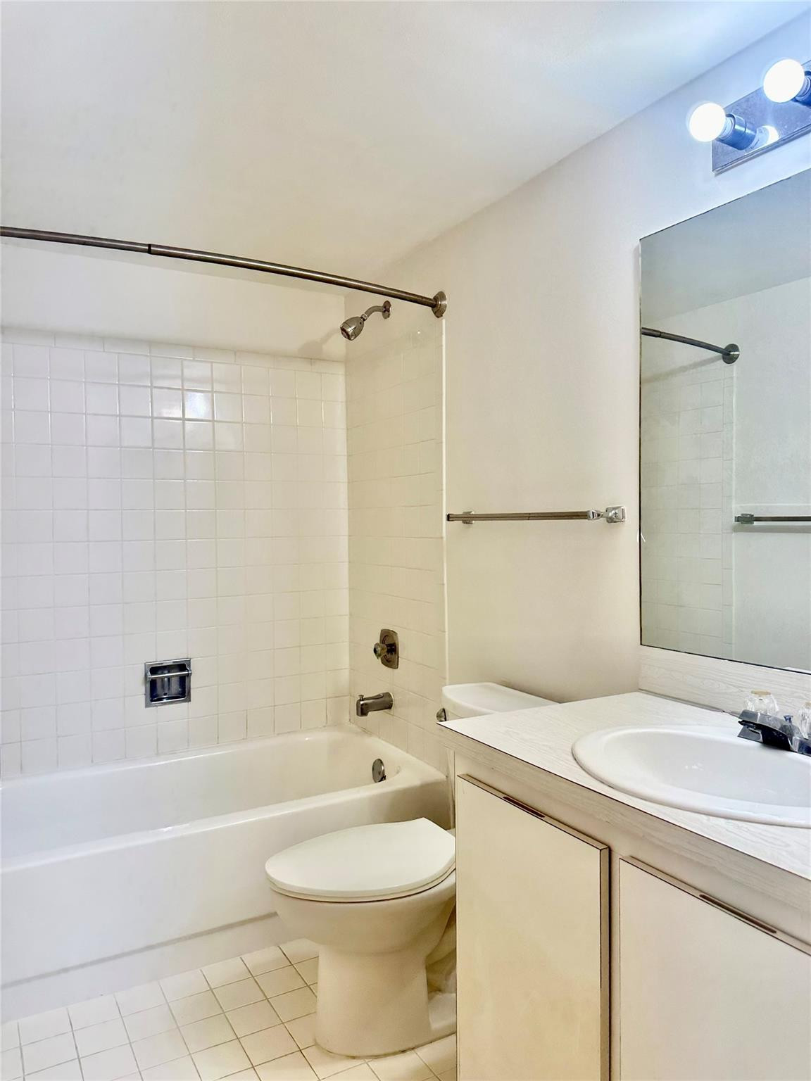 159 Northwest 70th Street, Unit 517 Boca Raton, FL 33487 - Photo 25 of 30 a bathroom with a sink toilet and shower