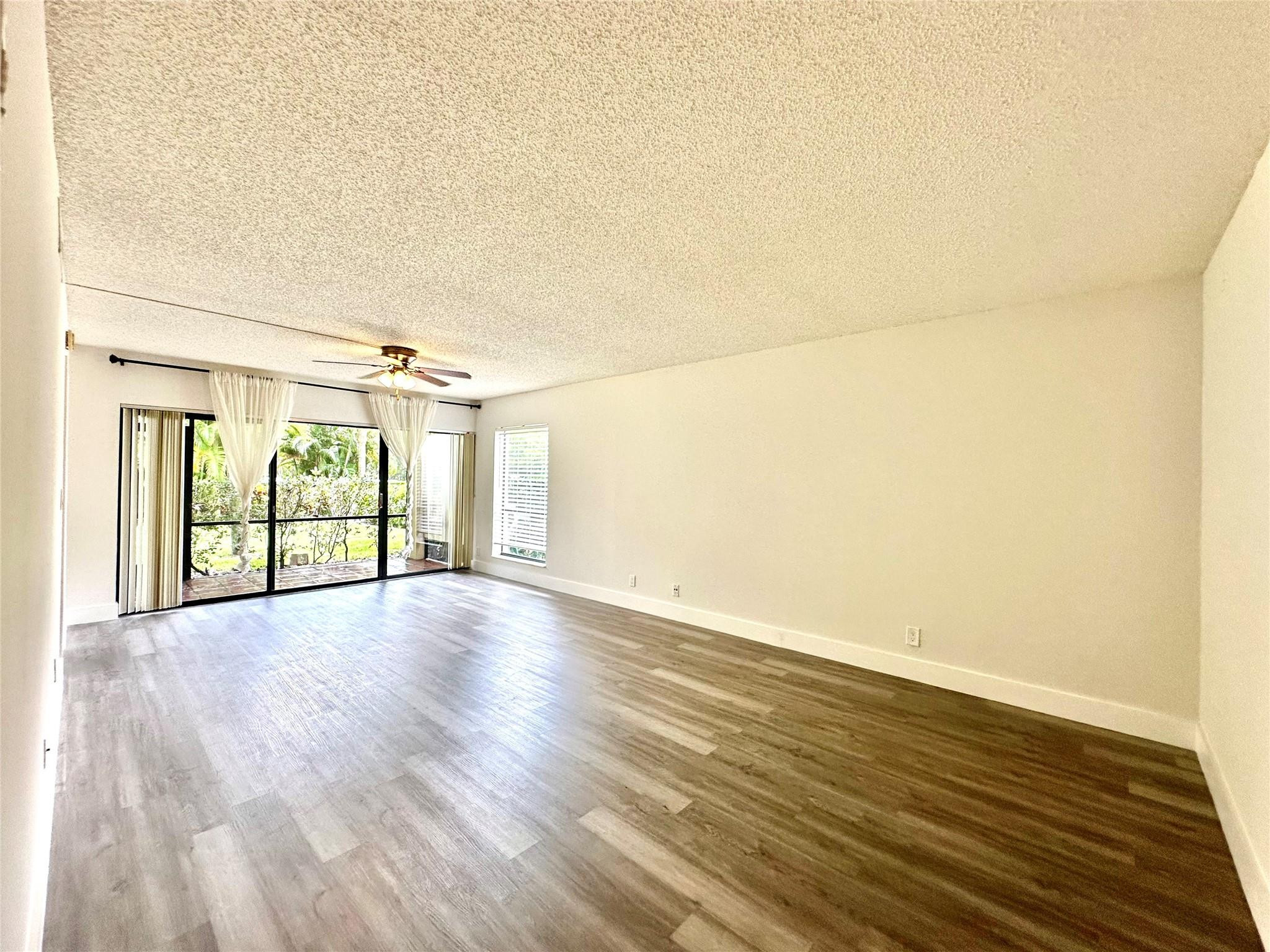 159 Northwest 70th Street, Unit 517 Boca Raton, FL 33487 - Photo 7 of 30 wooden floor in an empty room with a window