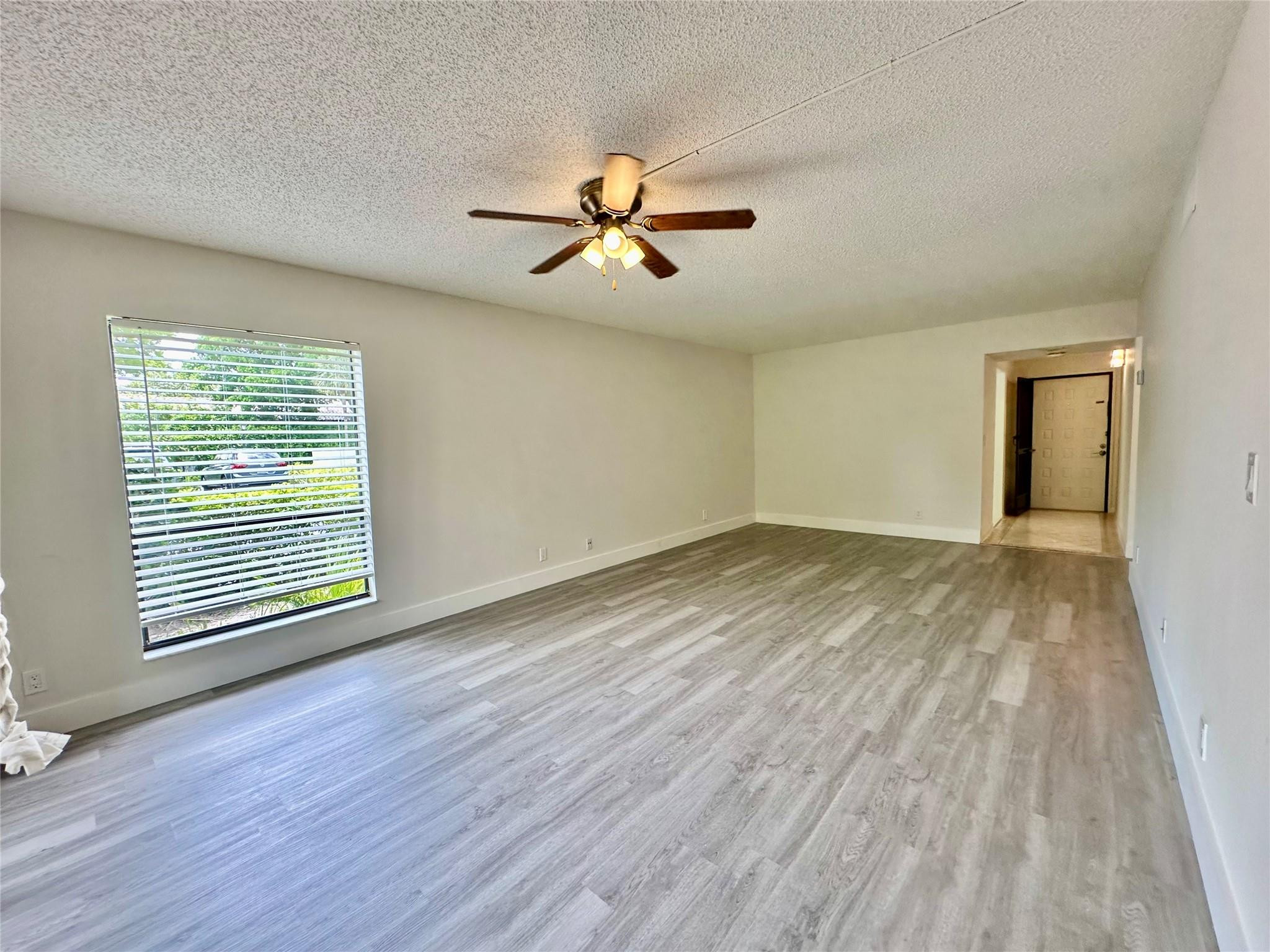 159 Northwest 70th Street, Unit 517 Boca Raton, FL 33487 - Photo 10 of 30 wooden floor in an empty room with a window