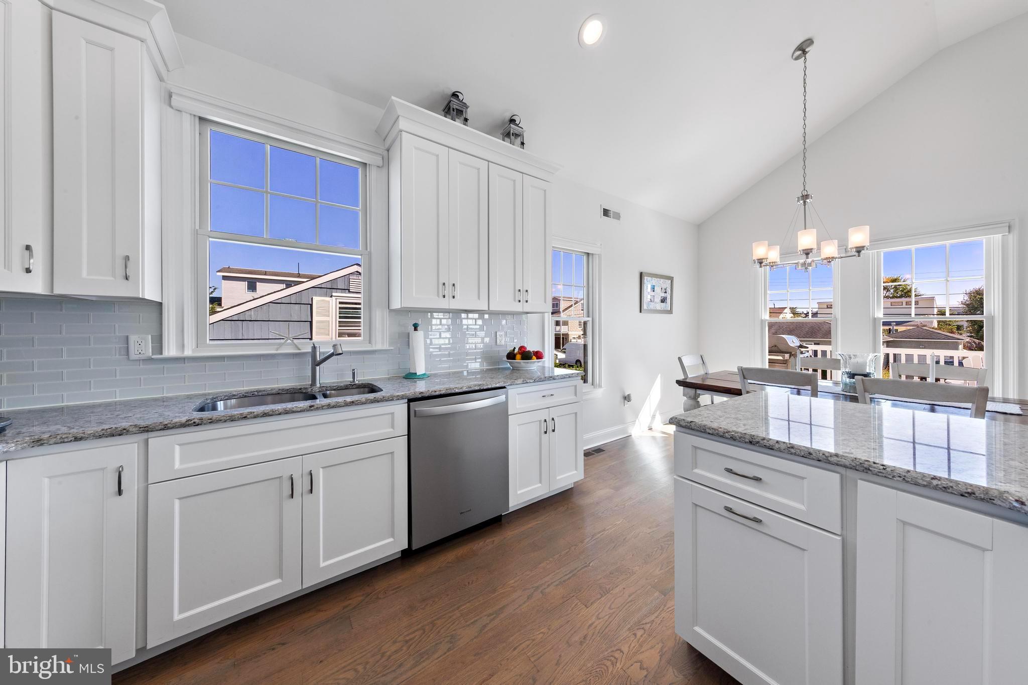 369 West 10th Street Ship Bottom, NJ 08008 - Photo 16 of 110 a kitchen with kitchen island granite countertop a sink cabinets and stainless steel appliances
