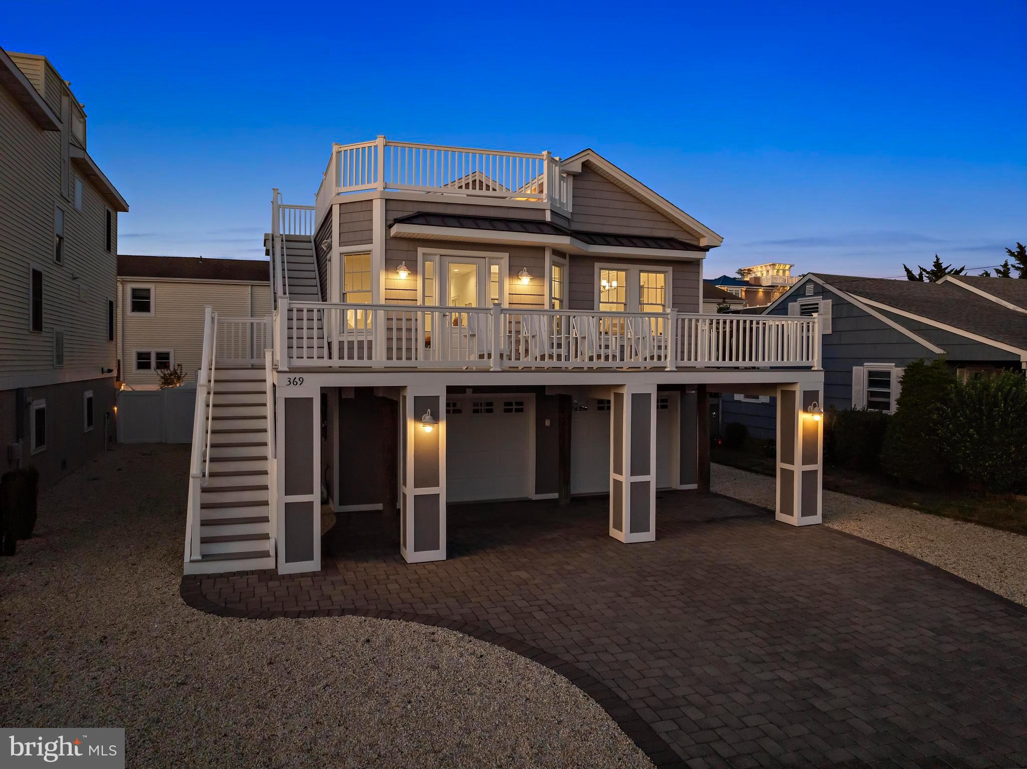 369 West 10th Street Ship Bottom, NJ 08008 - Photo 2 of 110 a front view of a house with garden