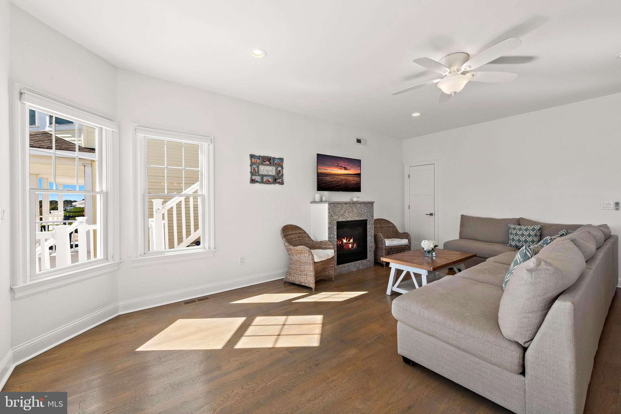369 West 10th Street Ship Bottom, NJ 08008 - Photo 24 of 110 a living room with furniture a fireplace and a window