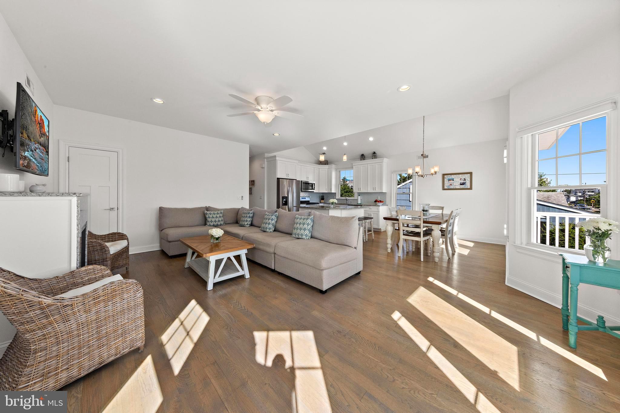 369 West 10th Street Ship Bottom, NJ 08008 - Photo 28 of 110 a living room with furniture and a dining table with wooden floor