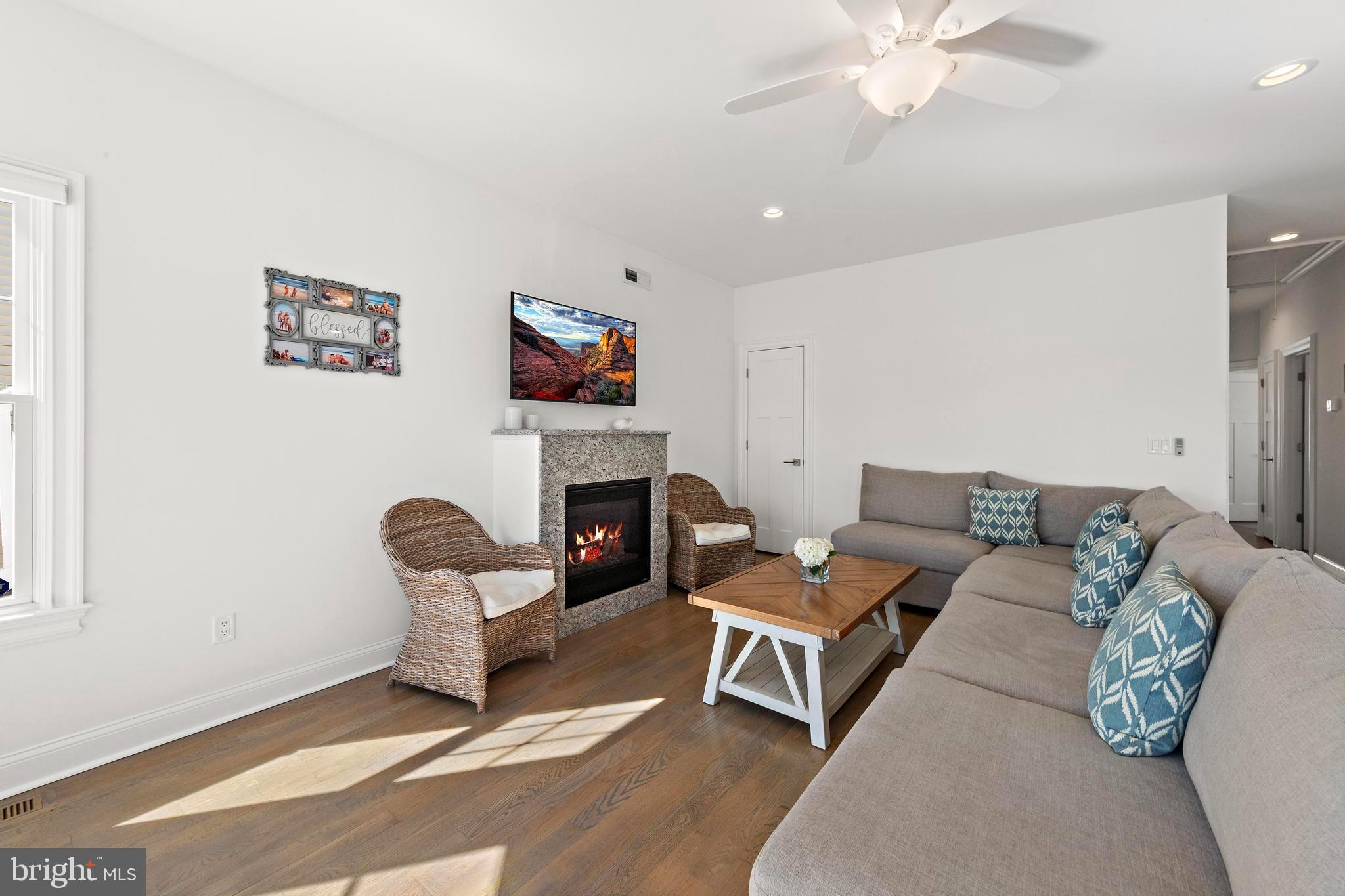 369 West 10th Street Ship Bottom, NJ 08008 - Photo 31 of 110 a living room with furniture a fireplace and a flat screen tv