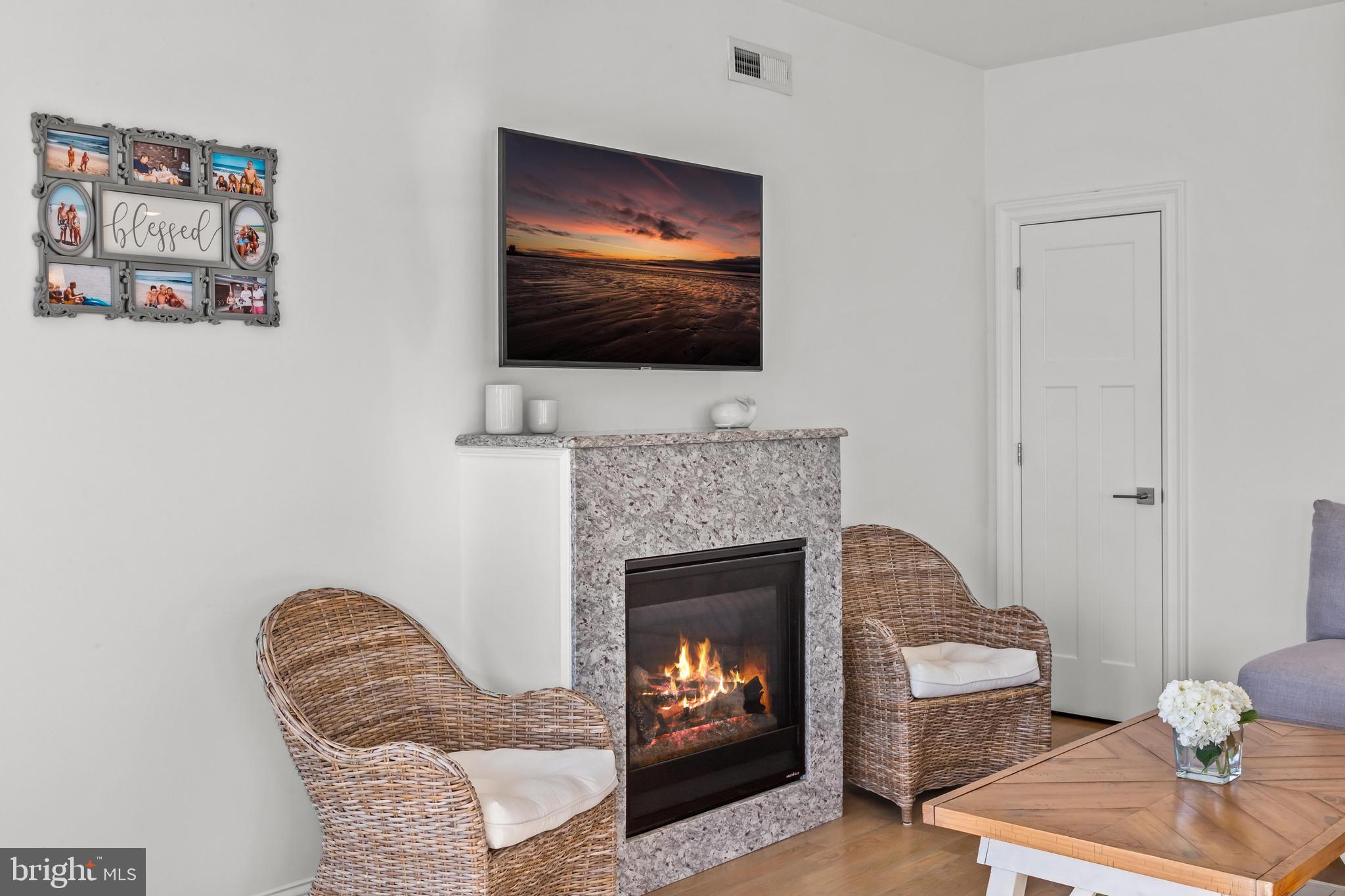369 West 10th Street Ship Bottom, NJ 08008 - Photo 33 of 110 a living room with furniture a flat screen tv and a fireplace