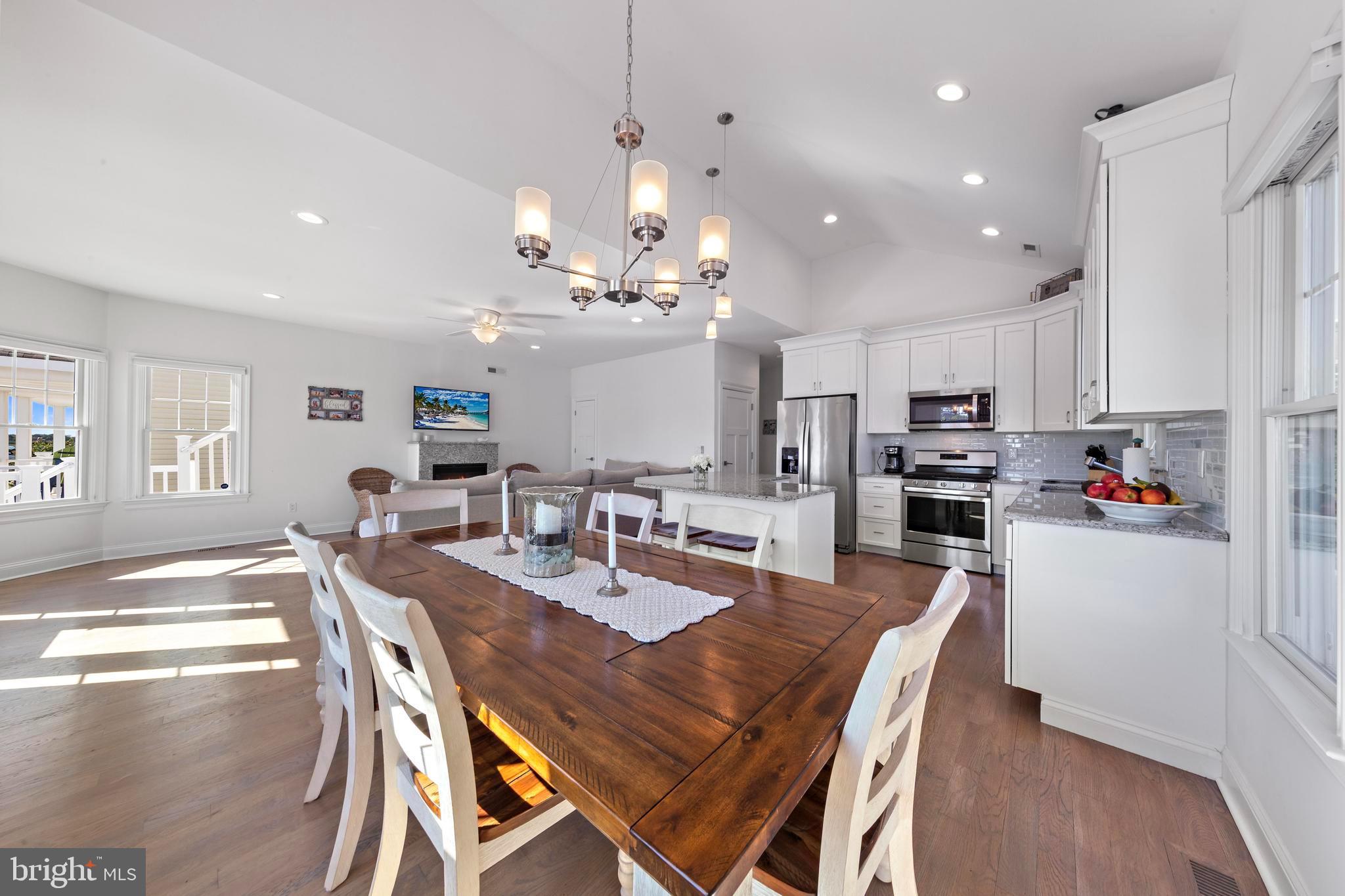 369 West 10th Street Ship Bottom, NJ 08008 - Photo 40 of 110 a view of a dining room and livingroom with furniture wooden floor a chandelier
