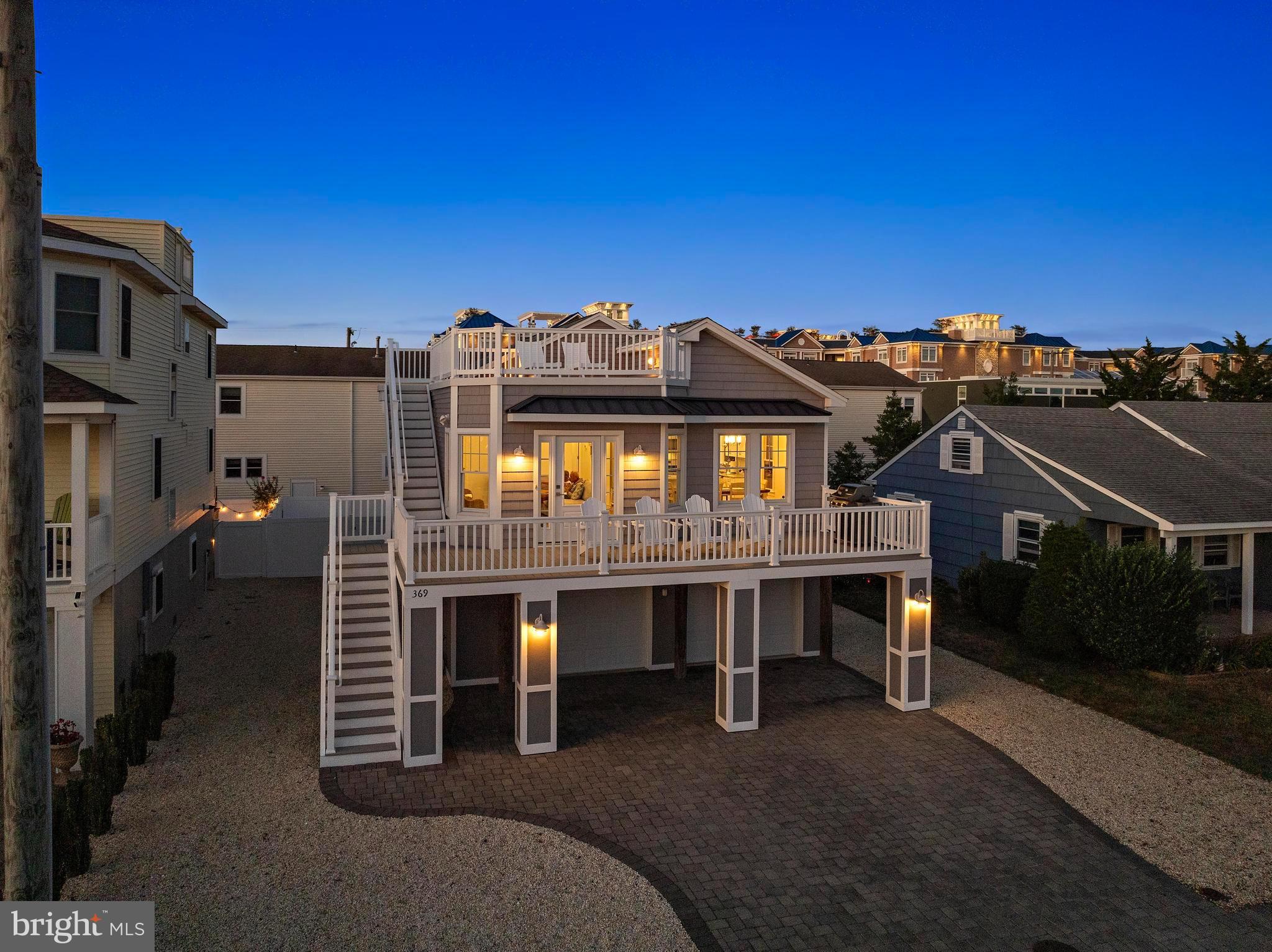 369 West 10th Street Ship Bottom, NJ 08008 - Photo 4 of 110 a view of a big building with a table and chairs