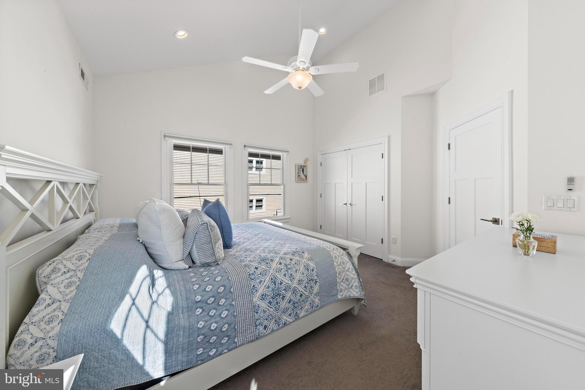 369 West 10th Street Ship Bottom, NJ 08008 - Photo 43 of 110 a bedroom with a large bed and a chandelier