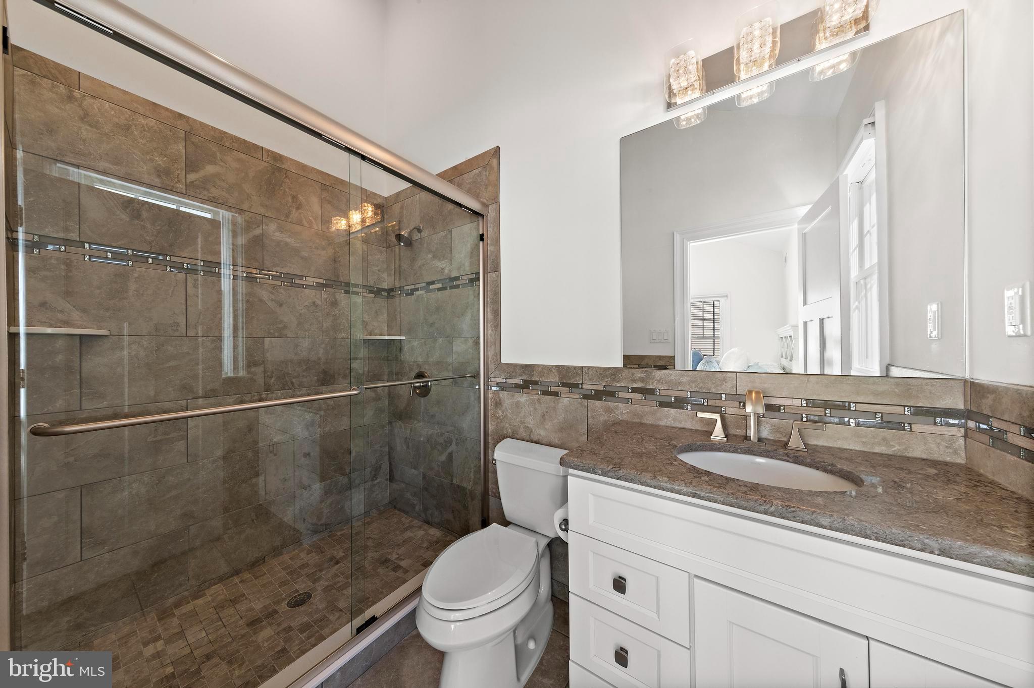369 West 10th Street Ship Bottom, NJ 08008 - Photo 44 of 110 a bathroom with a granite countertop sink a toilet and shower