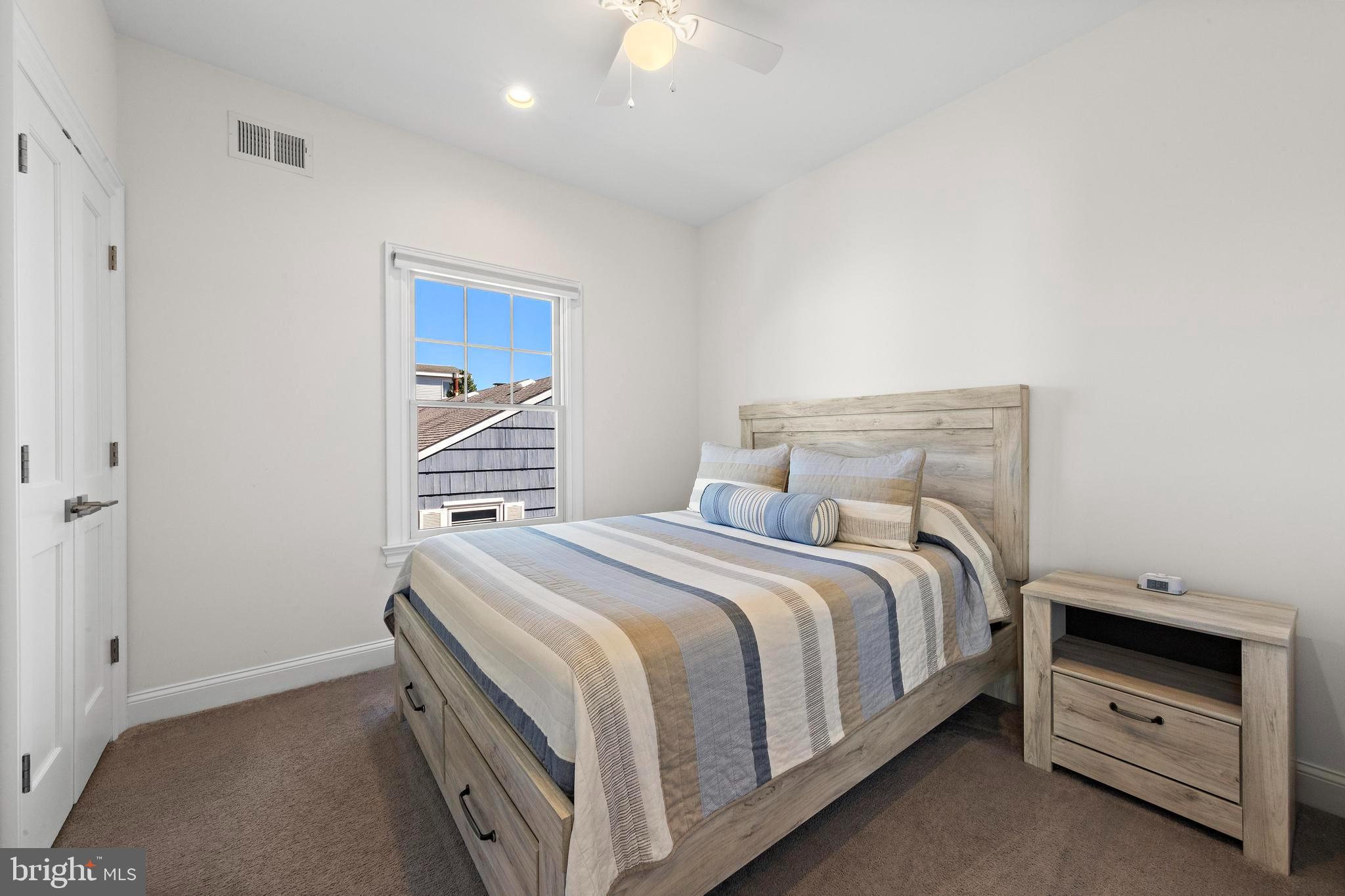 369 West 10th Street Ship Bottom, NJ 08008 - Photo 45 of 110 a bedroom with a bed and a ceiling fan