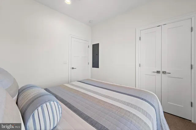 an aerial view of a city with lots of residential buildings and ocean view in back