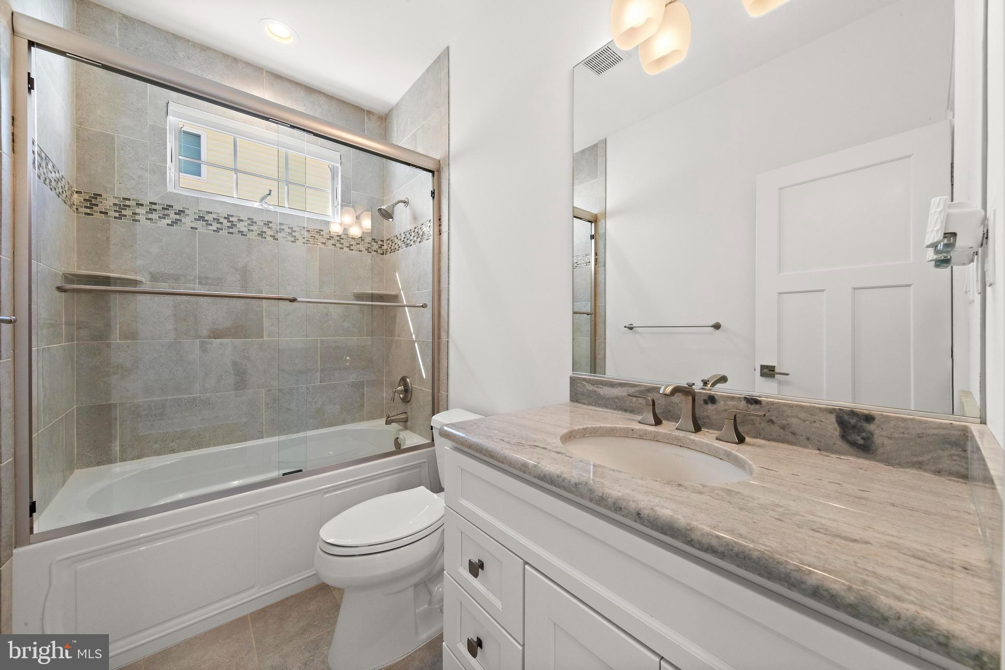 369 West 10th Street Ship Bottom, NJ 08008 - Photo 49 of 110 a bathroom with a granite countertop sink a toilet and shower
