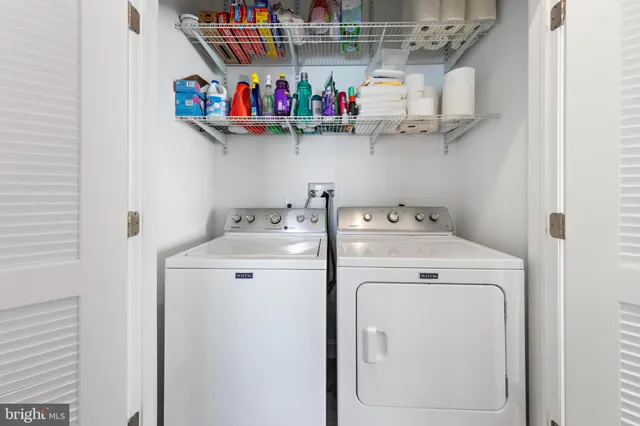 an aerial view of ocean and residential houses with outdoor space