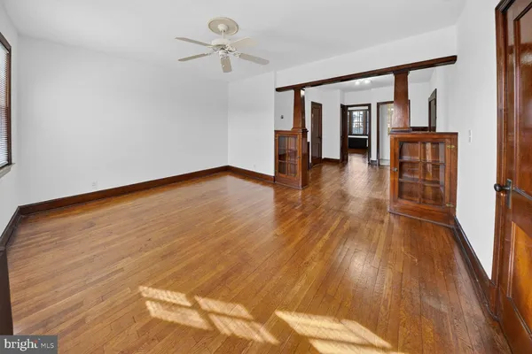 a view of empty room with wooden floor