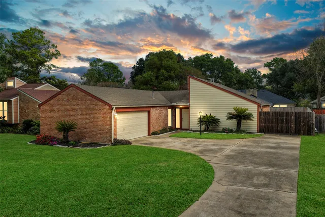 a front view of house with a garden