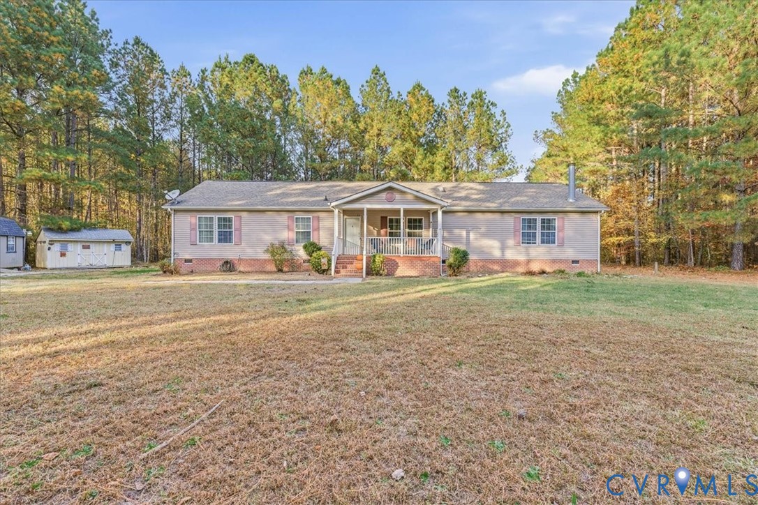 a front view of a house with a yard and trees
