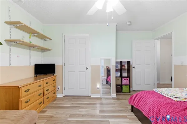 a bedroom with a bed and a flat tv screen tv