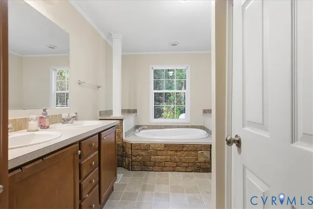 a spacious bathroom with a sink and a mirror