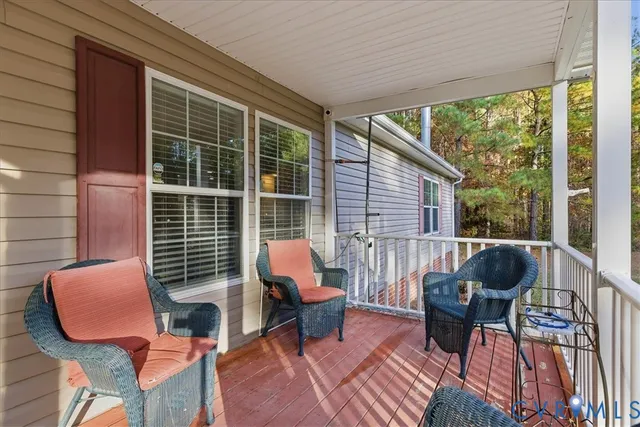 a balcony with couches and a potted plant