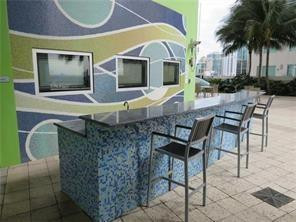 185 Southwest 7th Street, Unit 3507 Miami, FL 33130 - Photo 12 of 19 a front view of a house with garden and patio