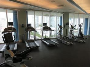 185 Southwest 7th Street, Unit 3507 Miami, FL 33130 - Photo 14 of 19 a room with gym equipment and windows